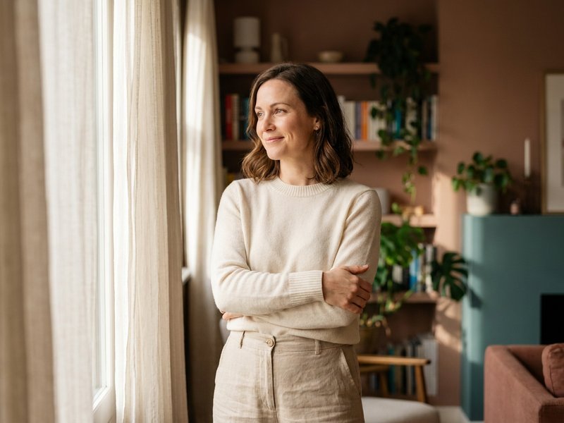 debt payoff tips — Her Own Compass, woman feeling confident about her debt payoff progress